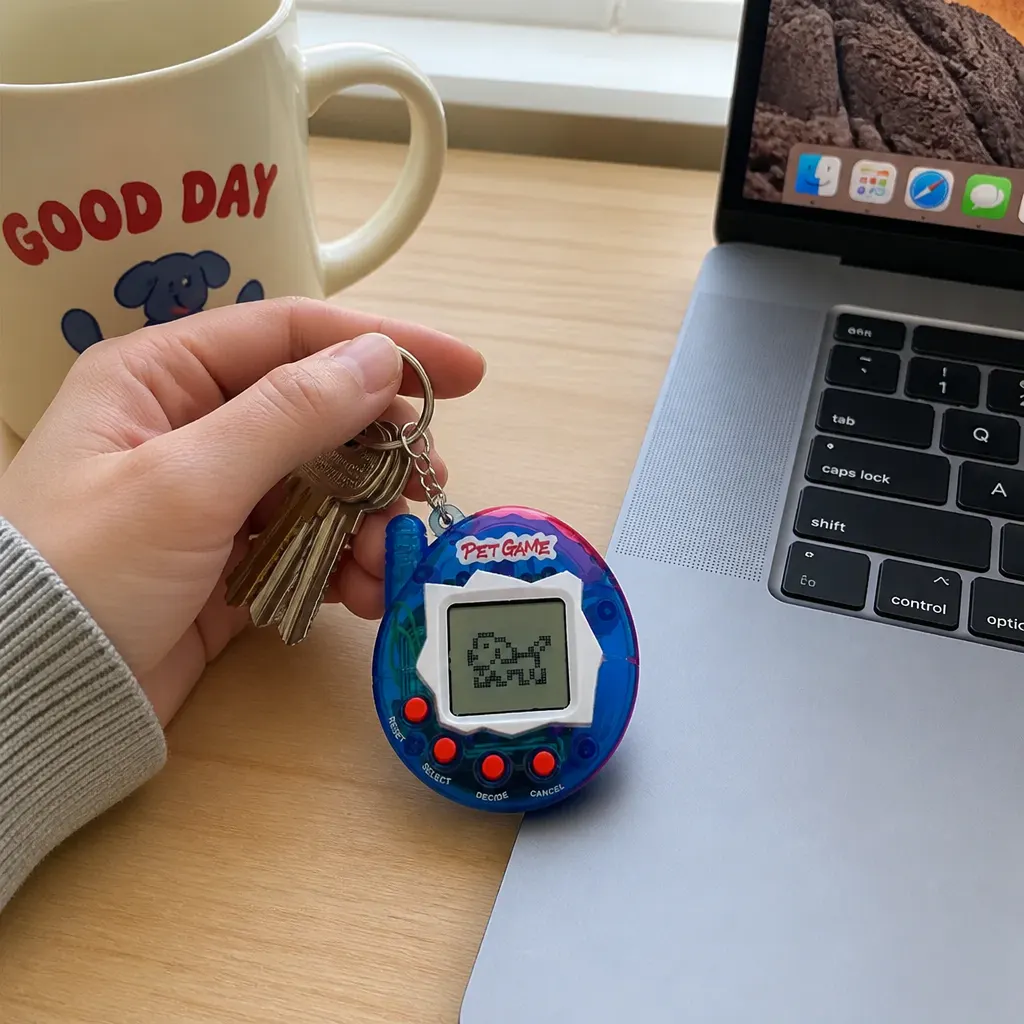 Translucent virtual pet keychain with live pixel pet on screen, clipped to keys