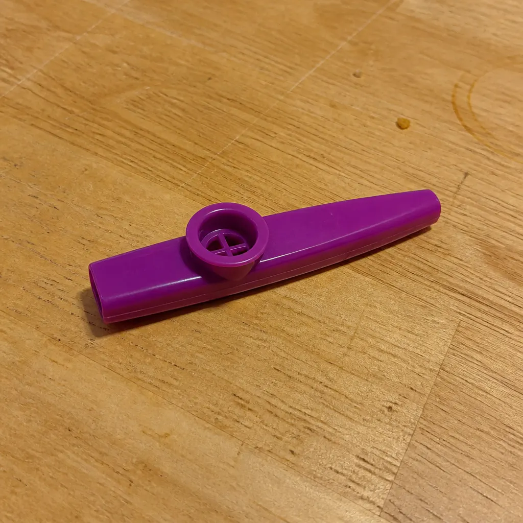 A flat plastic dollar-store kazoo